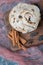 Fried meringue cookie with black raisines on a wooden board