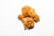 Fried mouth-watering chicken wings in a sauce and brown breading lie side by side in a yin and yang pose isolated on an empty