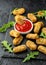 Fried mozzarella cheese sticks in breadcrumbs with ketchup sauce and wild rocket leaves