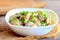 Fried mushrooms slices in a sour cream sauce. Tasty mushrooms with sour cream and green onions in a bowl. Healthy vegetarian dish