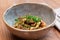 Fried mushrooms with soy sauce and scallions close-up