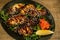 Fried mussels in mayonnaise sauce served on a plate of arugula with lemon, wasabi and sesame seeds