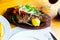 Fried mutton with vegetables in the wooden service plate