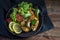 Fried northern pike steaks with lemon, lettuce salad, tomatoes a