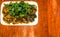 Fried one-thousand-year egg with crispy holy basil leaves and rice dish on a wood table background with space