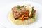 Fried perch fillet with rice and vegetables. On a white plate. On a white background. Isolated Close-up