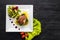 Fried piece of meat with herbs and spices on wooden background