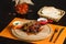 Fried pieces of veal with pepper and sesame seeds. Arabic cuisine dish on a wooden board.