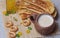 Fried pies, cheese, sunflower oil, milk and bagels on a plate cl