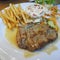 Fried pork chop, French fries and vegetable salad