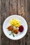 Fried pork meatballs with mashed potatoes and grated beets on wooden table