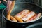 Fried pork and sausage cooking in the pan