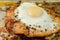 Fried portion of gammon served with egg on the metal plate