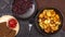 Fried potato chips in a pot with dark rye bread on a wooden plate and homemade stewed cabbage, on a black rustic background