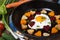 Fried potatoes, carrots, beets and egg in a heart shape