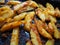 Fried potatoes or French fries with turmeric, curry and bread crumbs. Close-up. Delicious side dish. Bakery potatoes. Latin