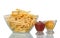 Fried potatoes in large glass bowl, ketchup and mustard isolated on white