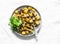 Fried potatoes with mushrooms and green salad - delicious simple vegetarian lunch on a light background, top view