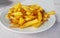 fried potatoes plate top view with salt and oregano vivid colors isolated background