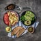 Fried potatoes with tomatoes, avocado, bread, topview