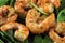 Fried prawns or shrimps on arugula rocket salad, close up shot