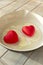 Fried red hearts eggs, vertical image in red and white. Simple home kitchen, love concept