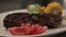 Fried rib eye steak on a plate, close up, sliding