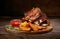 Fried ribs with rosemary, potatoes rustic, onion, sauce on wooden round Board. Dark background.