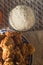 fried rice balls called bolinhos de arroz on a plate with copy space and striped background