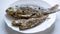 Fried river fish on white plate