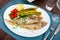 Fried roosterfish with asparagus, tomatoes and lemon