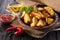 Fried rosemary potato wedges in a rustic setting.