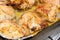 Fried ruddy chicken thighs on a baking sheet close-up