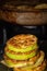 Fried ruddy courgettes folded stack against the background of the pan at the stove