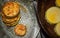 Fried ruddy courgettes are stacked in a column on a transparent patterned plate