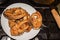 Fried ruddy pieces of fish on a white plate on a stove