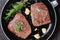 Fried rump beef steaks in a skillet