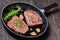 Fried rump beef steaks in a skillet