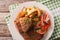 Fried rump steak and fresh vegetables, baked potatoes closeup. H