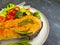 Fried salmon slice on a plate, tomato on concrete background nutrition