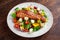 Fried Salmon steak with fresh vegetables salad, feta cheese. concept healthy food.