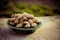 Fried salted almonds in shell. Useful nuts on wooden background.