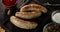 Fried sausage on a cutting board with spices.