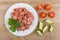 Fried sausage, parsley in plate, pieces of tomato and cucumber