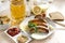 Fried sausages on a plate, ketchup, mustard, spices, beer mug