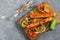 Fried sausages and vegetables on wooden plate