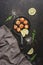 Fried scallops in a frying pan, dark stone background. Top view, overhead