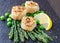 Fried scallops with sesame seeds, asparagus, lemon and green peas