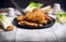 Fried schnitzel in pan with green lettuce leaves on old wooden table