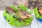 Fried sea bass on a plate with greens